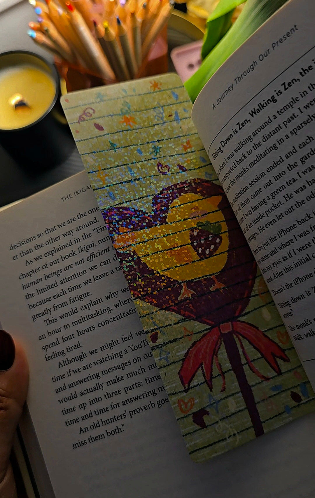 Sweet Chick holographic bookmark in use inside a book showing full design with kawaii chick on candy stick