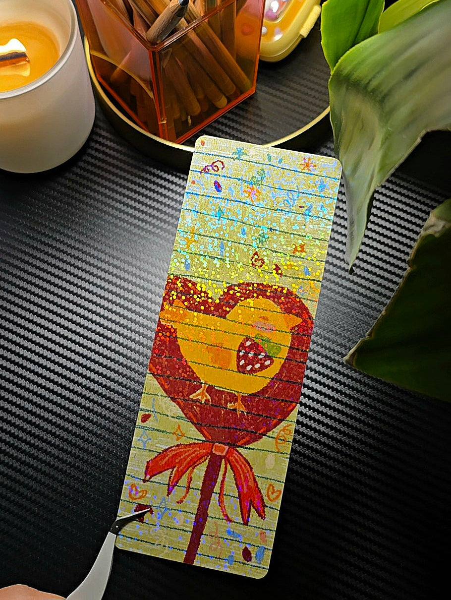 Sweet Chick holographic bookmark flat lay showing kawaii chick on a candy stick with bow on sparkly background