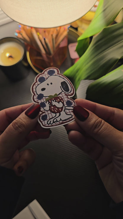 Berry Cute Snoopy die-cut sticker – Snoopy wearing a red plaid blueberry-print outfit, hugging a strawberry, matte vinyl, 2x3 inch